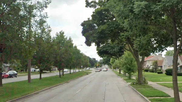 Street view of Sherman Blvd in Milwaukee, Wisconsin with landscaped median in middle of four-lane road.