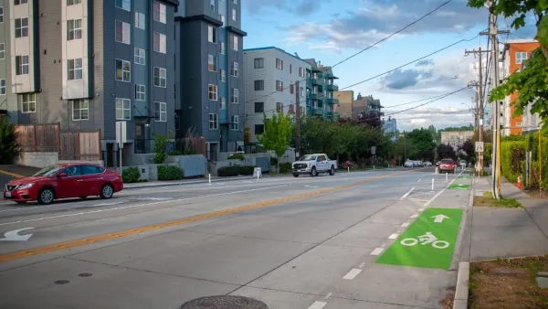 Green painted bike lane on street next to modern mid-rise apartment buildings in Seattle, Washington.