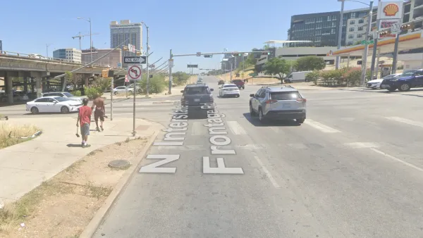 A concrete expanse is visible at the intersections of two wide roads in Austin, Texas.