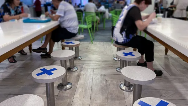 A restaurant in Singapore places tape on seats to maintain distance between diners during the Covid-19 pandemic in 2020.