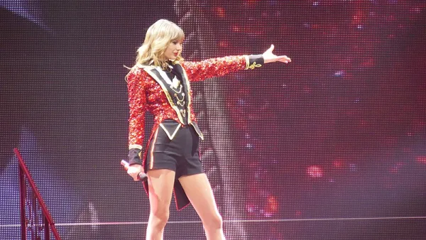Taylor Swift performs during the RED tour, 2013 wearing red and black ringmaster costume