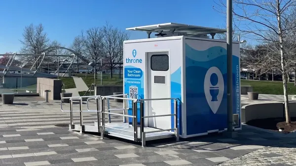 Blue and white Throne portable bathroom in an outdoor location.