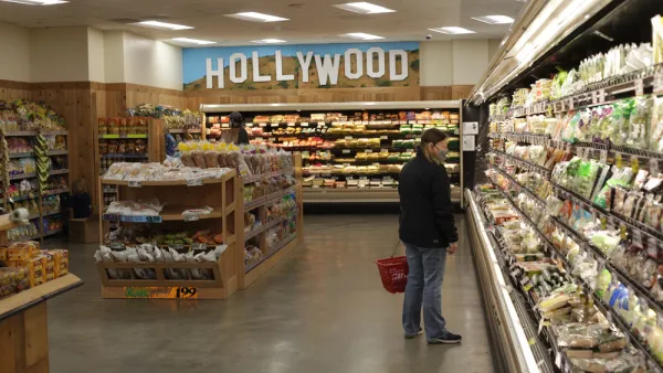 A woman in a mask shops at Trader Joe's.