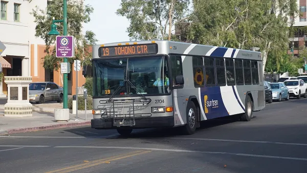 Silver and blue Sun Tran public transit bus on street in Tucson, Arizona.