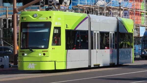 Green and gray Tempe streetcar on street in Tempe, Arizona