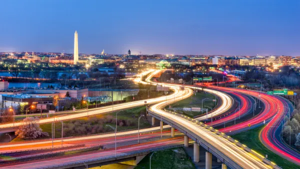 An image of Washington D.C. with highways and the streaks from car head and tail lights in the foreground, and the Washington Monument in the background.