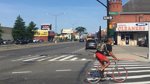 Person biking at intersection between Atlantic Avenue and Franklin Avenue in Brooklyn, New York City