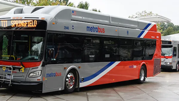 Silver and red WMATA public bus at station in Washington, D.C.