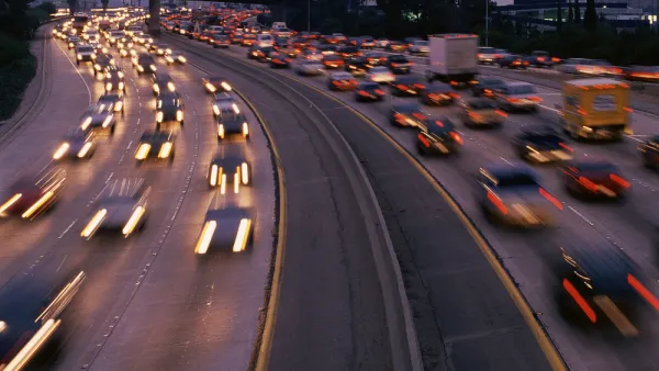 View of blurry speeding cars on freeway at sunset