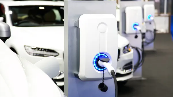 Row of white electric cars at charging station