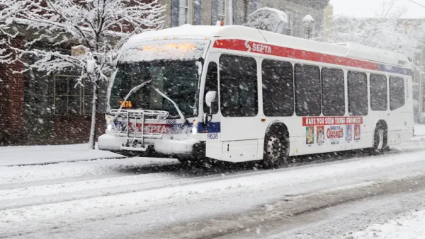 White SEPTA bus driving through snow in Philadelphia, Pennsylvania