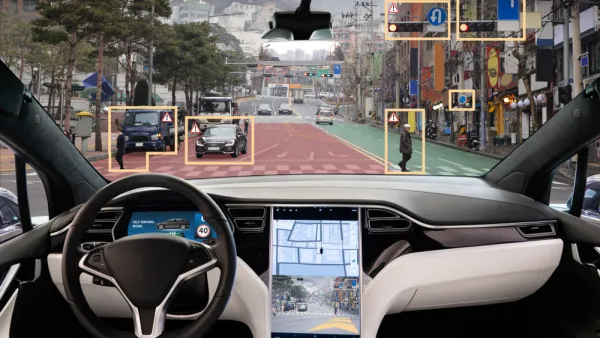 View from inside driver's seat of car with autonomous technology, with yellow rectangles highlighting obstacles in road