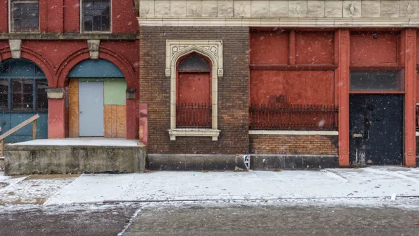 Boarded-up facade of vacant brick building in CIncinnati, Ohio