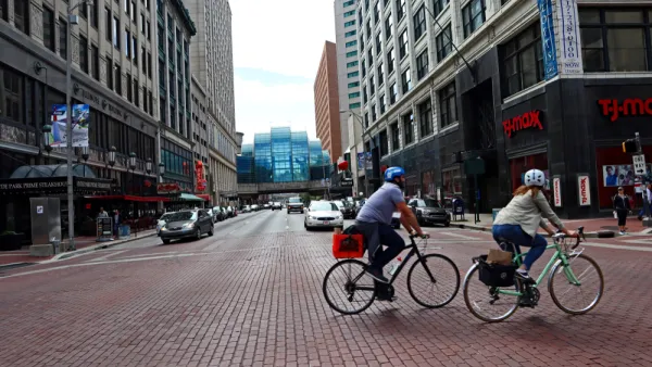 Two bicyclists on a street in downtown Indianapolis, Indiana