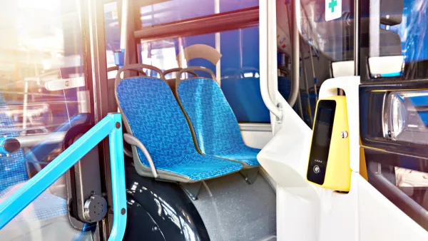 Cashless fare validator on bus with blue seat upholstery