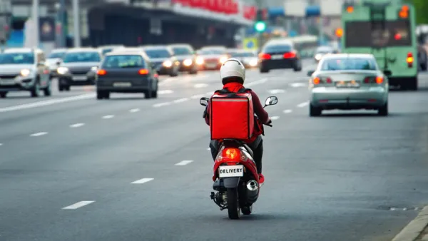 Back view of delivery scooter on roadway