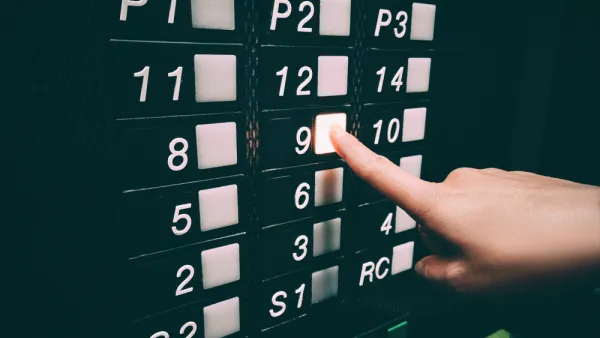 Close-up of black elevator panel qith square white buttons missing 13th floor, person pushing floor 9