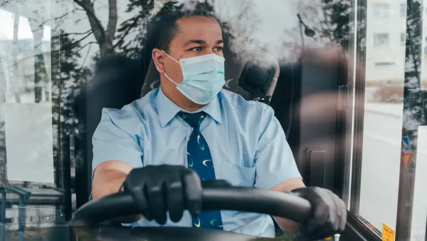 Bus driver wearing a COVID-19 protective mask