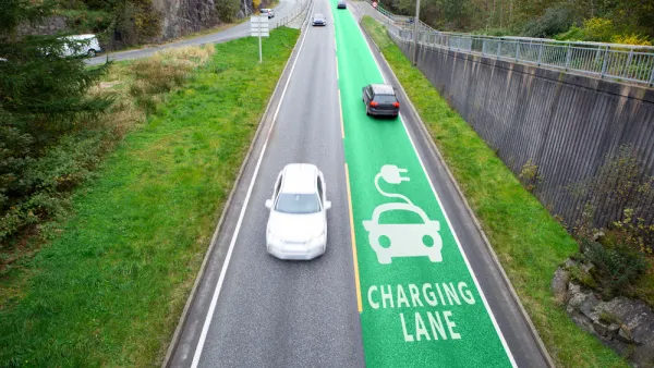 Road with one green electric vehicle charging lane