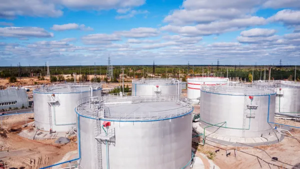Aerial view of cylindrical silver oil tanks