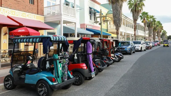 Line of colorful golf carts parked outside restaurant in The Villages, Florida