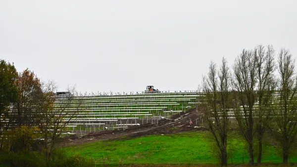 Solar panels on green inclined field on old landfill site in The Netherlands