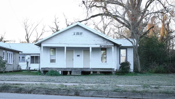 Dilapidated vacant wood slat house painted white in Louisiana