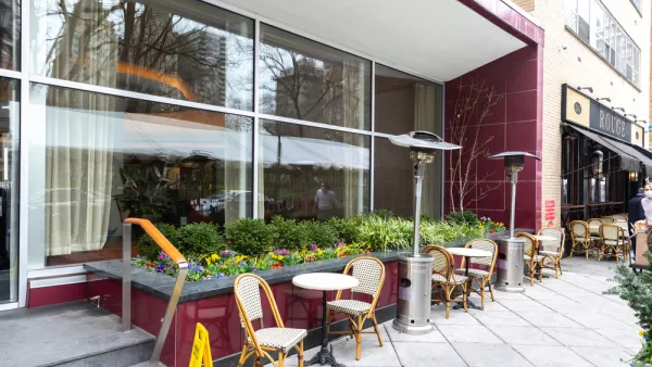 Empty chairs and tables on sidewalk at a Phialdelphia restaurant