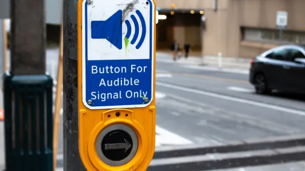 Close-up of crosswalk button for blind pedestrians labeled "button for audible signal only"