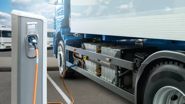 Concept rendering of white electric big rig truck plugged into charging station