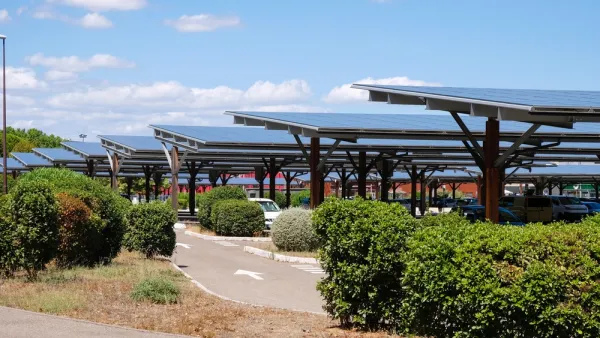 Solar panels shading cars in parking lot in Avignon, France