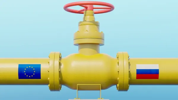 Yellow gas pipeline with E.U. flag on one side and Russia flag on the other side