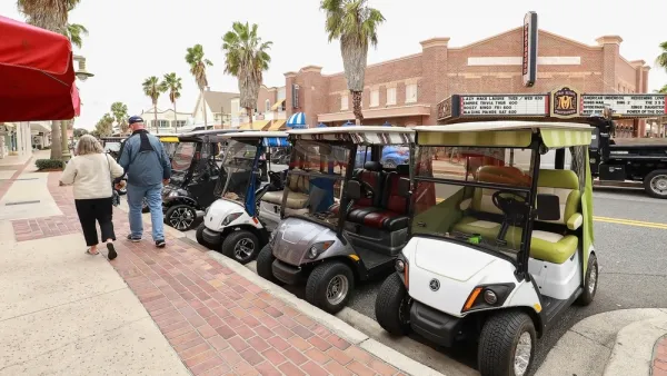Line of golf carts parked on street in The Villages, Florida