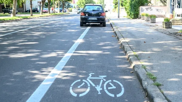 Black car parked in bike lane
