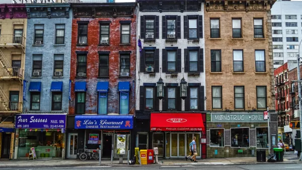 Multicolored four-story New York City buildings with storefronts on ground floor