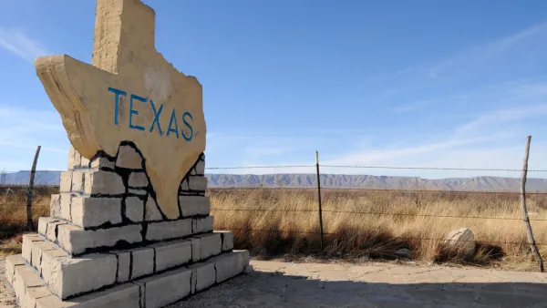 Texas-shaped road sign with TEXAS text on rural roadside