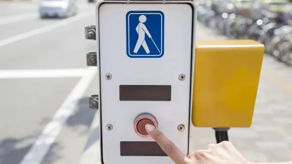 Crosswalk button with illustration of visually impaired pedestrian