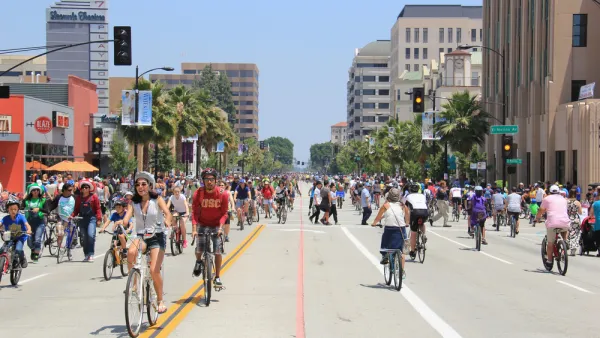 Many people on bikes riding on city street during CicLAvia event in Pasadena, California