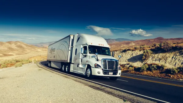 Diesel big rig truck on California road with mountains in background