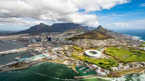 Aerial view of Cape Town, South Africa with development on coast and mountains in background