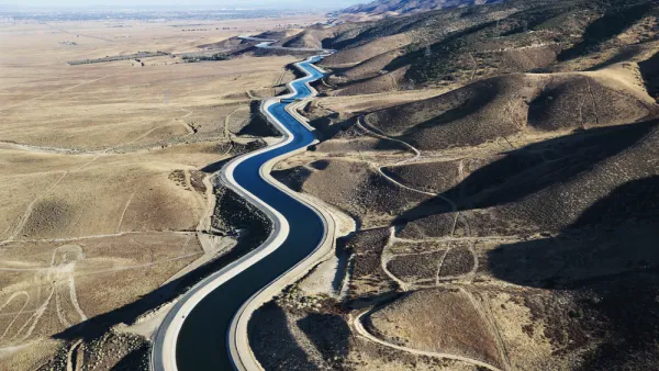 Aerial view of California aqueduct snaking through arid hills outside Los Angeles