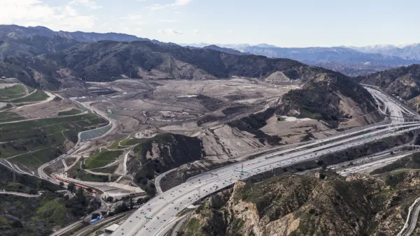 Aerial view of I-5 freeway and large landfill in hilly part of Los Angeles County