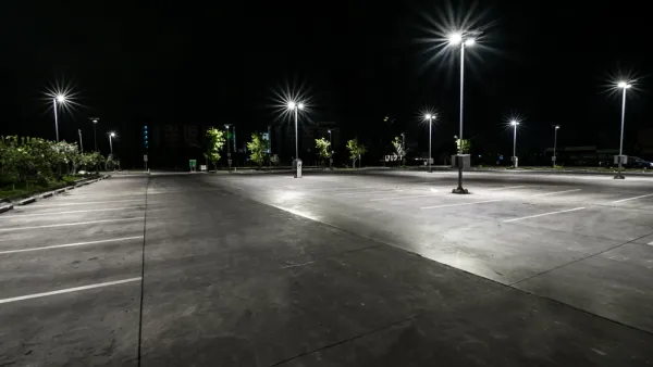Asphalt parking lot at night with bright lights