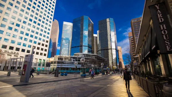 Pedestrians walking in downtown Denver, Colorado surrounded by tall office towers
