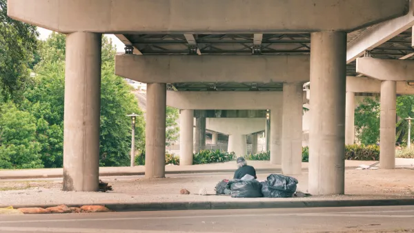 Unhoused person under a freeway overpass in Houston, Texas