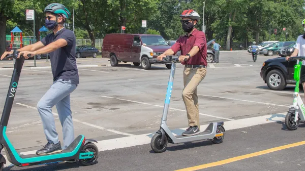 Three people wearing helmets riding electric scooters in New York City